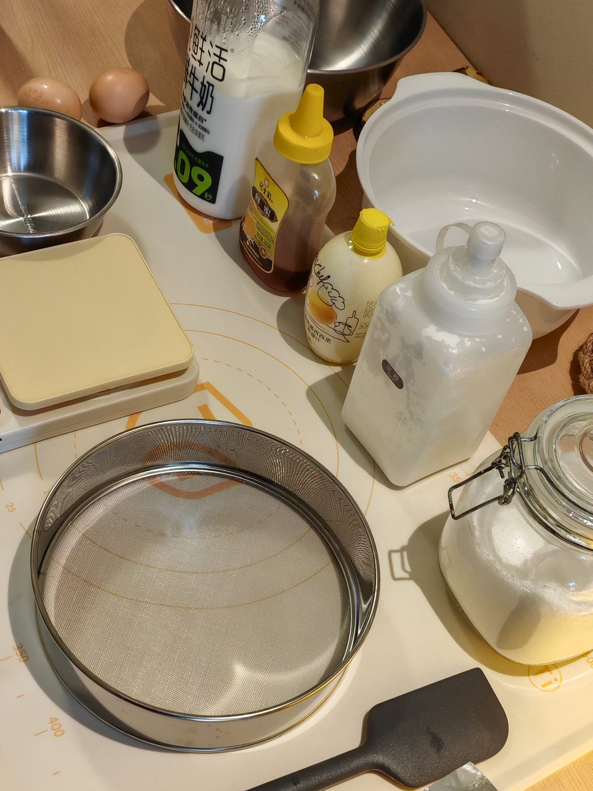 Ingredients and tools for homemade Basque burnt cheesecake on a kitchen counter - Whisk and Purr