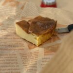 A slice of perfect Basque burnt cheesecake served on parchment paper