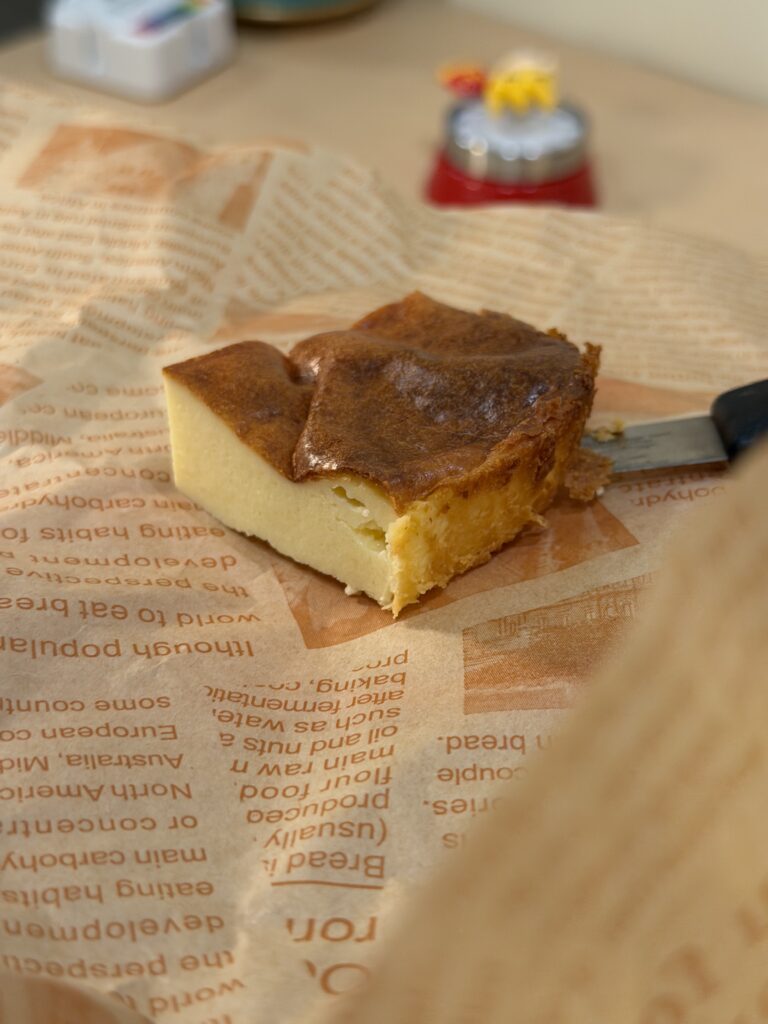 A slice of perfect Basque burnt cheesecake served on parchment paper